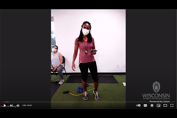 woman in athletic gear leading a virtual exercise class